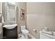 Small bathroom with toilet, sink, and decorative mirror at 40610 N Bradon Ct, Phoenix, AZ 85086