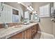 Bathroom with double sinks and wood cabinets at 40610 N Bradon Ct, Phoenix, AZ 85086