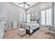 Bright bedroom with wood floors, a comfy bed, and plantation shutters at 40610 N Bradon Ct, Phoenix, AZ 85086