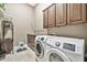 Laundry room with washer, dryer, and ample cabinetry at 40610 N Bradon Ct, Phoenix, AZ 85086