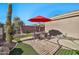 Enjoy outdoor dining under a red umbrella on the patio at 40610 N Bradon Ct, Phoenix, AZ 85086