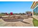 Stone pool deck with built-in seating and two lounge chairs at 40610 N Bradon Ct, Phoenix, AZ 85086