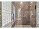 Large shower with granite tile and glass block accent wall at 40610 N Bradon Ct, Phoenix, AZ 85086