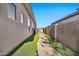 Landscaped side yard with a concrete pathway and lighting at 40610 N Bradon Ct, Phoenix, AZ 85086