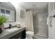 Modern bathroom with gray tile, walk-in shower, and updated vanity at 413 W Marco Polo Rd, Phoenix, AZ 85027