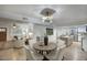 Modern dining area with a round table, stylish chairs, and light hardwood floors at 413 W Marco Polo Rd, Phoenix, AZ 85027