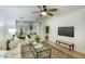 Open concept living area with hardwood floors, modern decor, and a view into the dining area at 413 W Marco Polo Rd, Phoenix, AZ 85027