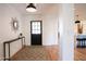 Light and airy entryway with black front door, console table, and geometric rug at 4525 N 82Nd St, Scottsdale, AZ 85251