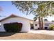 White single story home with red bushes and palm trees at 4525 N 82Nd St, Scottsdale, AZ 85251