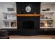 Black brick fireplace with built-in shelving at 4525 N 82Nd St, Scottsdale, AZ 85251