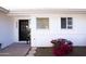 Black front door with glass block window and red flowers at 4525 N 82Nd St, Scottsdale, AZ 85251