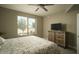 Bedroom with large window, ceiling fan, and wood dresser at 4805 N Woodmere Fairway Ln # 1012, Scottsdale, AZ 85251