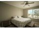 Bright bedroom with a floral bedspread and ceiling fan at 4805 N Woodmere Fairway Ln # 1012, Scottsdale, AZ 85251