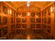 Large wine cellar featuring extensive wooden storage and a tasting table at 4805 N Woodmere Fairway Ln # 1012, Scottsdale, AZ 85251