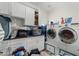 Laundry room with washer, dryer, and built-in cabinets at 500 W Jasper Dr, Chandler, AZ 85225