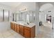 Double vanity bathroom with a large mirror and a view into the bedroom at 5025 E Waltann Ln, Scottsdale, AZ 85254