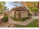 Front view of a tan house with a walkway and landscaping at 5025 E Waltann Ln, Scottsdale, AZ 85254