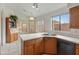 Kitchen nook with wood cabinets, a double sink, and a view of the backyard at 5025 E Waltann Ln, Scottsdale, AZ 85254