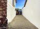 Private backyard access between two buildings with a wooden gate at 5036 W Gelding Dr, Glendale, AZ 85306