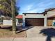 House exterior with brown garage door and terracotta roof at 5036 W Gelding Dr, Glendale, AZ 85306