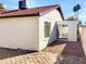 View of home's side exterior, showing patio and gravel area at 5036 W Gelding Dr, Glendale, AZ 85306