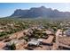 Aerial view showing a house with a pool and a large yard, with mountains in the background at 5271 E Shiprock St, Apache Junction, AZ 85119