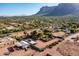 Aerial view of a house with a pool, large yard, and detached workshop at 5271 E Shiprock St, Apache Junction, AZ 85119