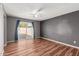 Bedroom with laminate wood floors and sliding glass door at 5715 W Heatherbrae Dr, Phoenix, AZ 85031