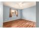 Spacious bedroom featuring wood-look floors and a ceiling fan at 5715 W Heatherbrae Dr, Phoenix, AZ 85031