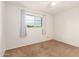 Bright bedroom with neutral walls, carpet, and a ceiling fan at 5715 W Heatherbrae Dr, Phoenix, AZ 85031