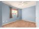 Bright bedroom with light blue walls, carpet, and a ceiling fan at 5715 W Heatherbrae Dr, Phoenix, AZ 85031