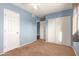 Bedroom with blue walls, ceiling fan, and double door closet at 5715 W Heatherbrae Dr, Phoenix, AZ 85031