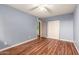 Bedroom with wood-look floors, double door closet and ceiling fan at 5715 W Heatherbrae Dr, Phoenix, AZ 85031