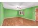 Bright living room with light wood floors and green walls at 5715 W Heatherbrae Dr, Phoenix, AZ 85031