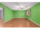 Spacious living room featuring light wood floors and green walls at 5715 W Heatherbrae Dr, Phoenix, AZ 85031