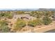 Aerial view of a single-story house with a landscaped front yard and mountain views at 5950 E Lowden Ct, Cave Creek, AZ 85331