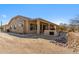 House exterior showcasing a covered patio and desert landscaping at 5950 E Lowden Ct, Cave Creek, AZ 85331