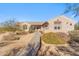 Single-story house with a landscaped front yard and walkway to entry at 5950 E Lowden Ct, Cave Creek, AZ 85331