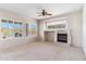 Living room with fireplace and plantation shutters at 5950 E Lowden Ct, Cave Creek, AZ 85331