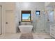 Elegant bathroom featuring a freestanding tub, walk-in shower, and marble finishes at 6406 E Helm Dr, Scottsdale, AZ 85254