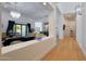 Light and airy entryway with hardwood floors, offering a view of the living room at 6406 E Helm Dr, Scottsdale, AZ 85254