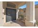 Front entry with seating area and double doors at 6406 E Helm Dr, Scottsdale, AZ 85254