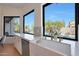 Modern kitchen with white cabinets, marble countertops, and a farmhouse sink at 6406 E Helm Dr, Scottsdale, AZ 85254