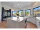 Large kitchen island with marble countertop and built-in microwave at 6406 E Helm Dr, Scottsdale, AZ 85254