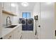 Laundry room with washer, dryer, and utility sink at 6406 E Helm Dr, Scottsdale, AZ 85254