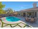 Relaxing pool area with patio furniture and a beautifully landscaped yard at 6406 E Helm Dr, Scottsdale, AZ 85254