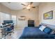 Bedroom with a large bed, a workspace, and a ceiling fan at 731 N Nantucket St, Chandler, AZ 85225