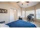 Bedroom with a large bed, a workspace, and a ceiling fan at 731 N Nantucket St, Chandler, AZ 85225