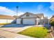 House exterior with three-car garage and landscaped lawn at 731 N Nantucket St, Chandler, AZ 85225