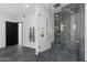 Elegant bathroom with a frameless glass shower and herringbone tile floor at 8200 N Charles Dr, Paradise Valley, AZ 85253